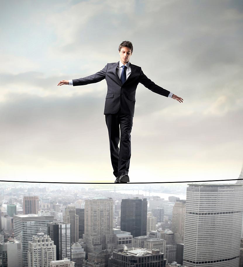 Person Walking the Wire Over City